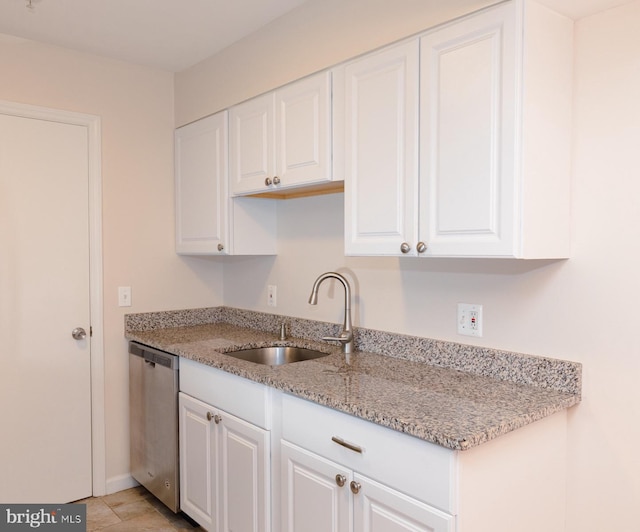 kitchen featuring white cabinets, light stone countertops, sink, and stainless steel dishwasher