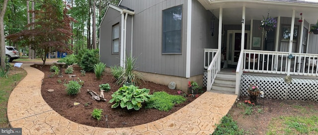 view of exterior entry with a porch