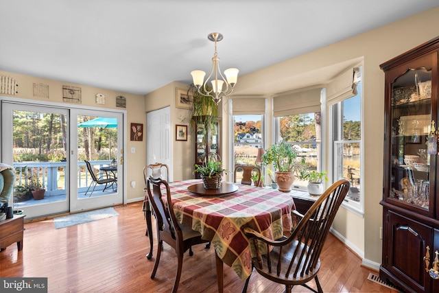 dining area featuring a chandelier and light wood-type flooring