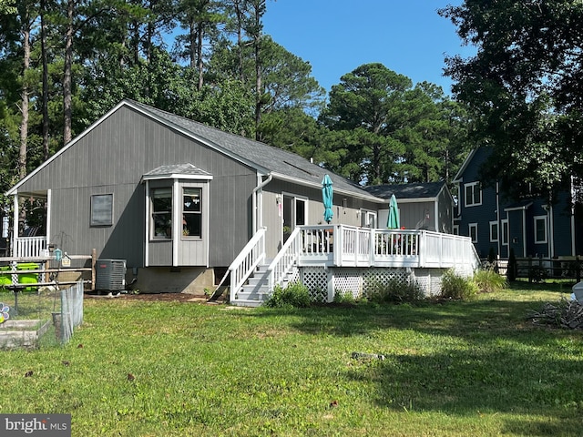 back of house with a yard, a wooden deck, and central air condition unit