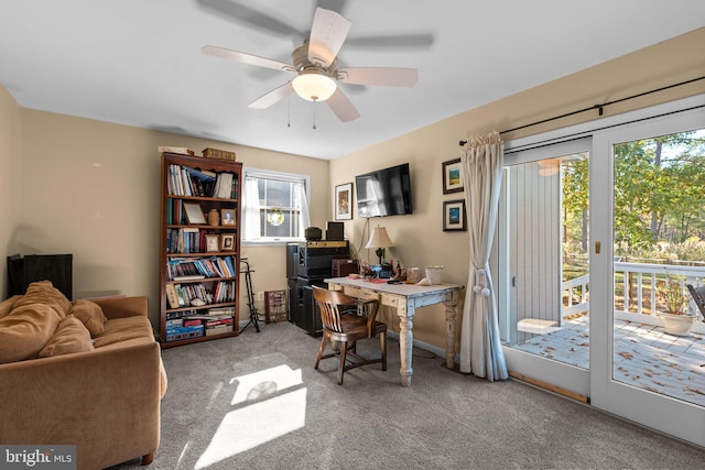 carpeted office space with ceiling fan and a wealth of natural light