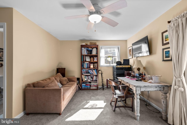 office space featuring light carpet and ceiling fan