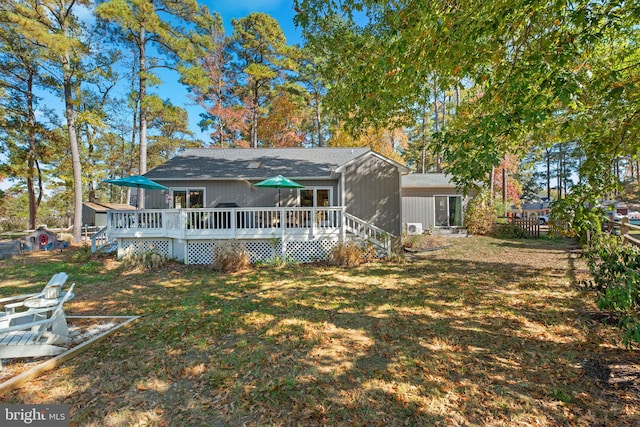 back of house featuring a deck and a yard