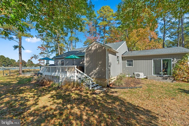 back of house featuring a yard, a wooden deck, and ac unit