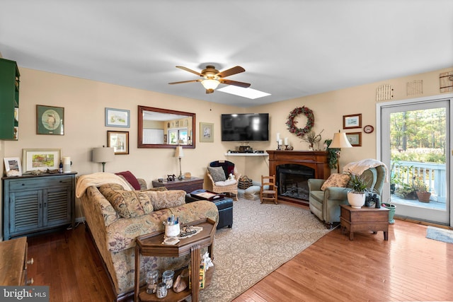 living room with ceiling fan and wood-type flooring