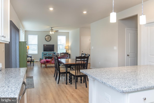 dining area featuring ceiling fan and light hardwood / wood-style flooring