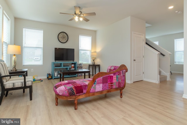 living room with ceiling fan, light hardwood / wood-style flooring, and plenty of natural light