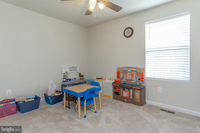 playroom with ceiling fan and light colored carpet