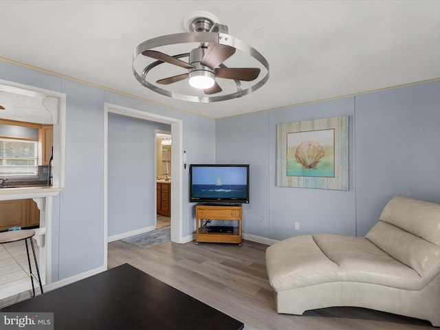 living room with light hardwood / wood-style floors and ceiling fan