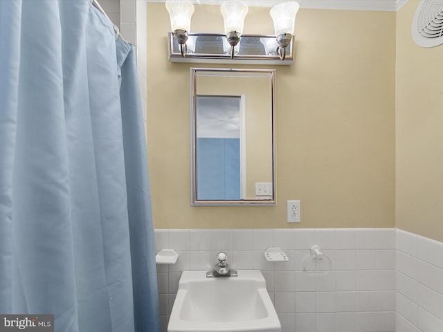 bathroom with tile walls and sink