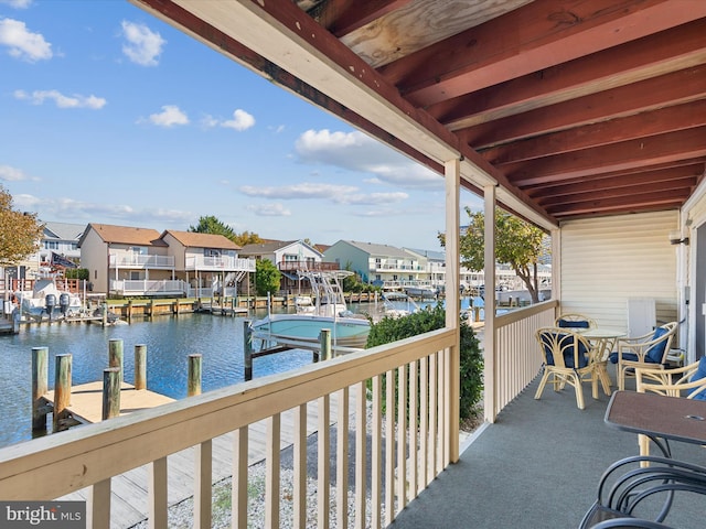 balcony featuring a dock and a water view