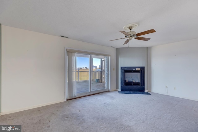 unfurnished living room with light colored carpet and ceiling fan