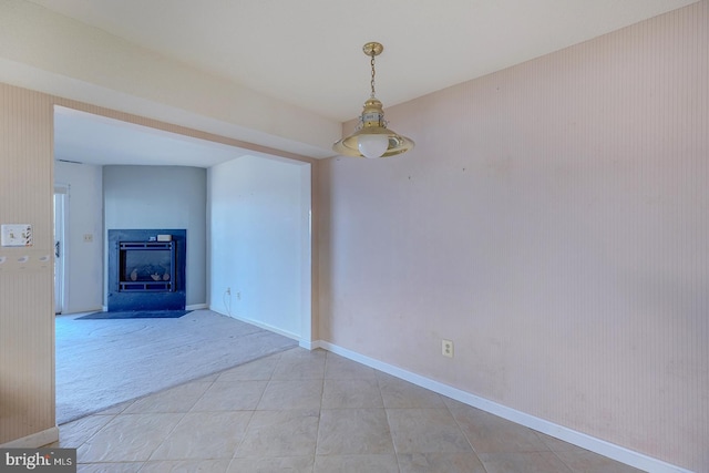 unfurnished room with a fireplace and light colored carpet