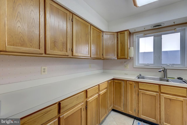 kitchen featuring light tile patterned flooring and sink