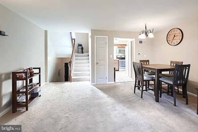 carpeted dining area with an inviting chandelier