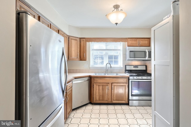 kitchen with stainless steel appliances, tasteful backsplash, and sink