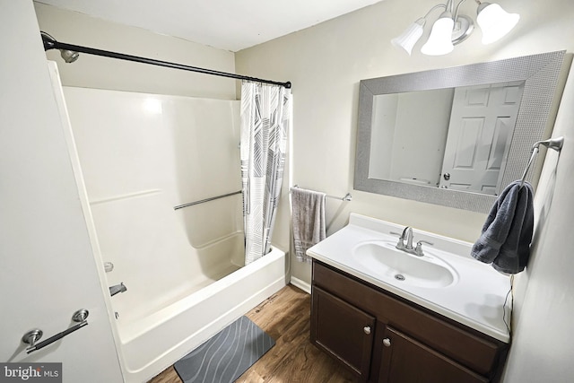 bathroom featuring wood-type flooring, vanity, and shower / bathtub combination with curtain