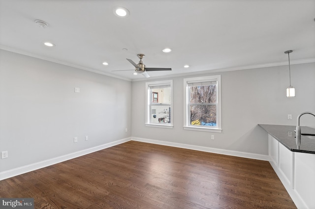 interior space with ceiling fan, sink, crown molding, and dark hardwood / wood-style flooring