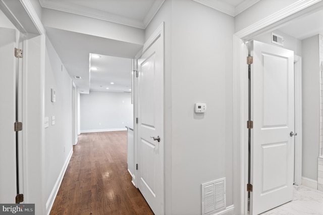 hallway with wood-type flooring and ornamental molding