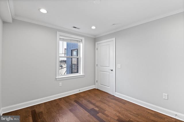 spare room with dark hardwood / wood-style floors and crown molding