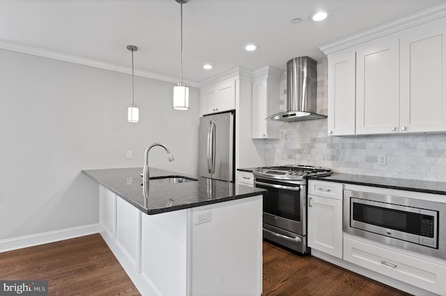 kitchen with sink, wall chimney range hood, white cabinetry, appliances with stainless steel finishes, and dark stone countertops