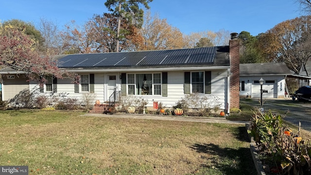 ranch-style home featuring solar panels and a front yard