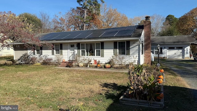 single story home featuring solar panels and a front yard