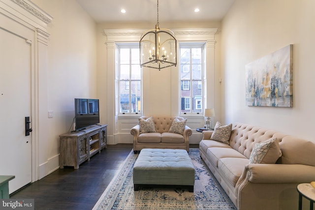 living room with dark hardwood / wood-style floors and a chandelier