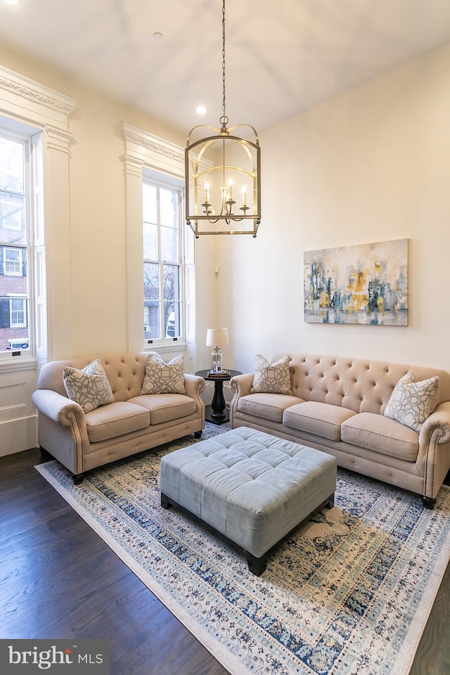 living room featuring dark wood-type flooring and a chandelier