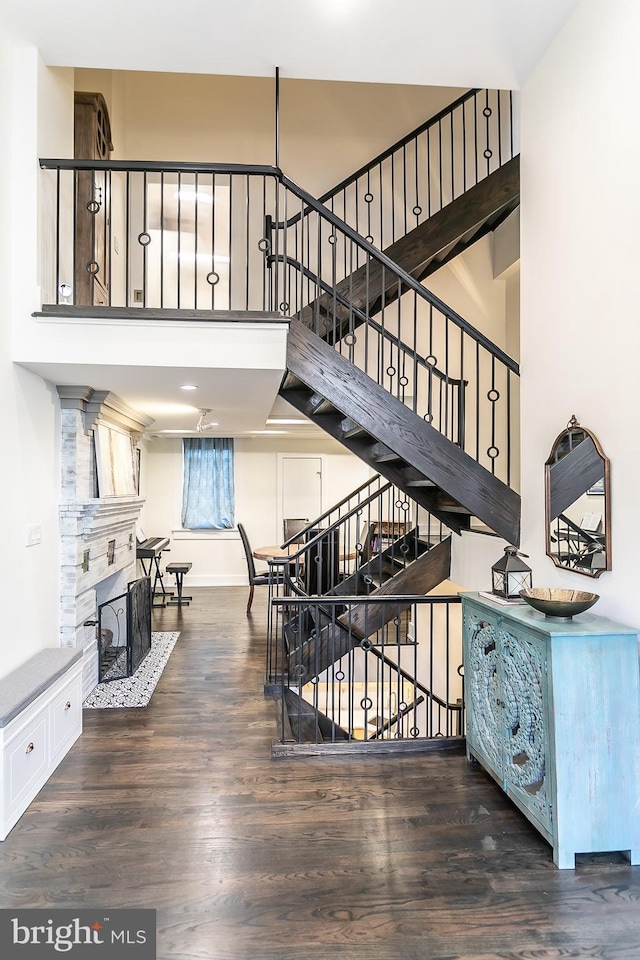1508 Pine St Unit A, Philadelphia, PA 19102 - stairs featuring baseboards, a high ceiling, wood finished floors, and a fireplace