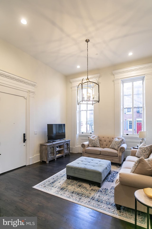 living room featuring a notable chandelier and dark hardwood / wood-style floors