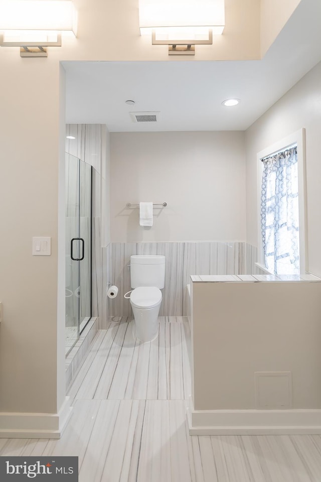 bathroom with toilet and walk in shower