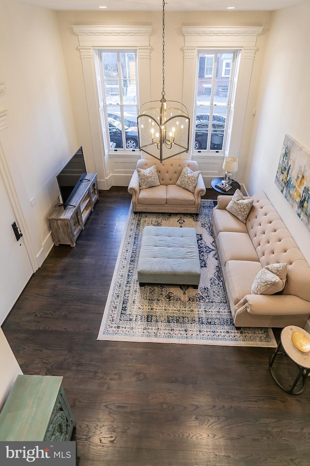 living room featuring a notable chandelier and dark hardwood / wood-style flooring