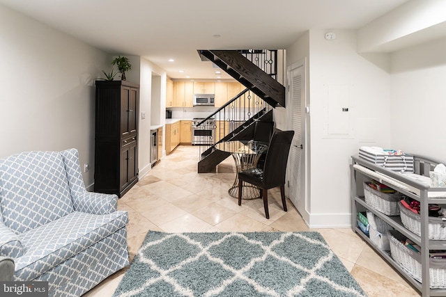 living area featuring beverage cooler and light tile patterned floors