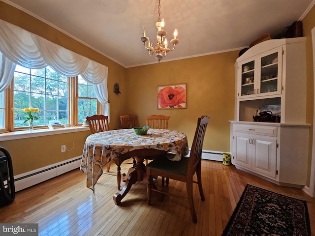 dining area with light hardwood / wood-style flooring, baseboard heating, and crown molding