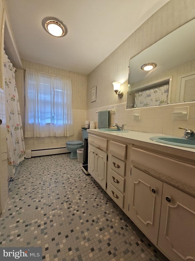 bathroom featuring vanity, tile walls, a baseboard radiator, and toilet