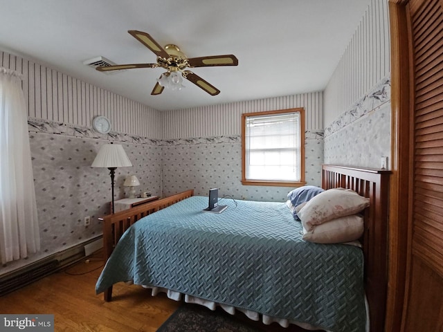 bedroom with wood-type flooring and ceiling fan