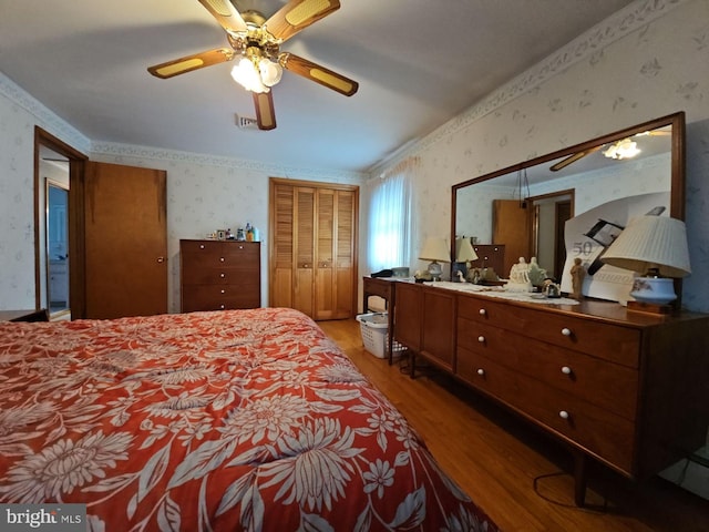 bedroom with ceiling fan, a closet, and light hardwood / wood-style floors