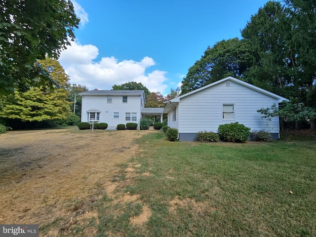 rear view of property with a lawn