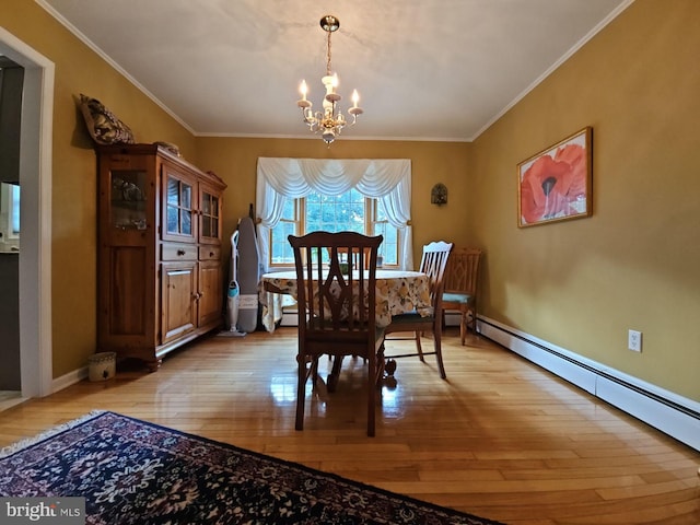 dining area featuring light wood-type flooring, ornamental molding, and a baseboard heating unit