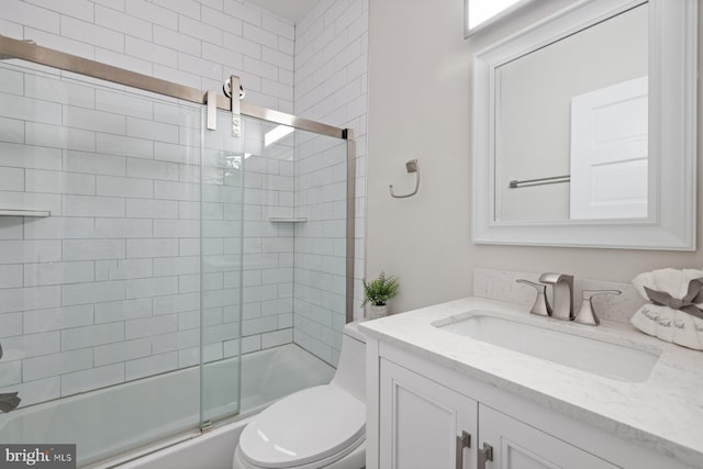 full bathroom featuring bath / shower combo with glass door, vanity, and toilet