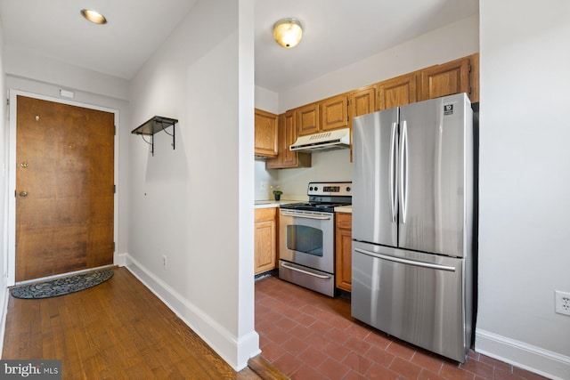 kitchen featuring stainless steel appliances and dark wood-type flooring