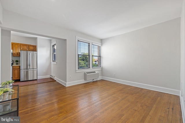 unfurnished living room with dark wood-type flooring and a wall mounted AC