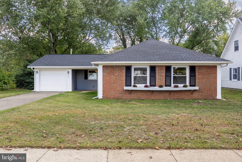 ranch-style home with a garage and a front yard