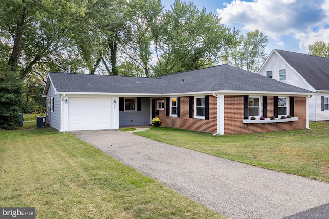 view of front of property with central air condition unit, a garage, and a front yard