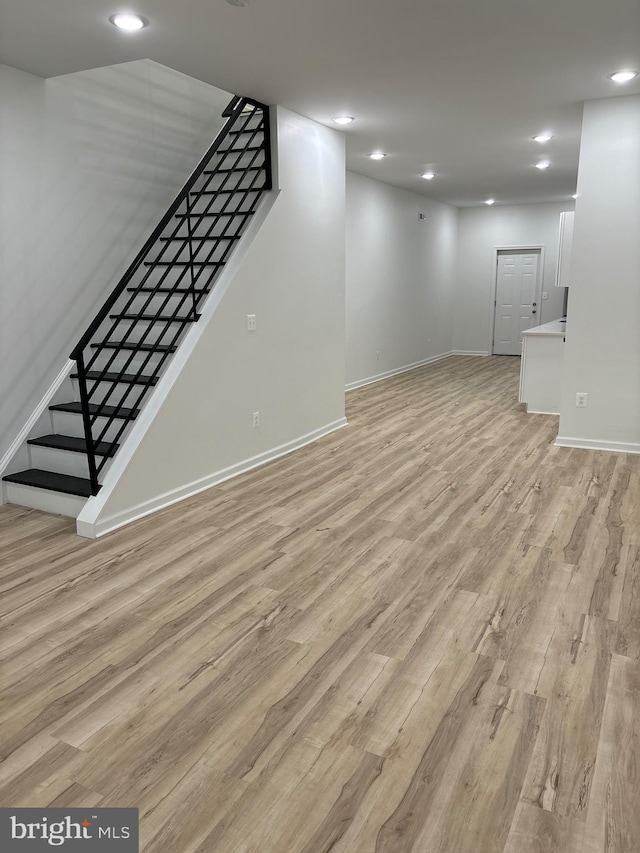 basement featuring light wood-type flooring