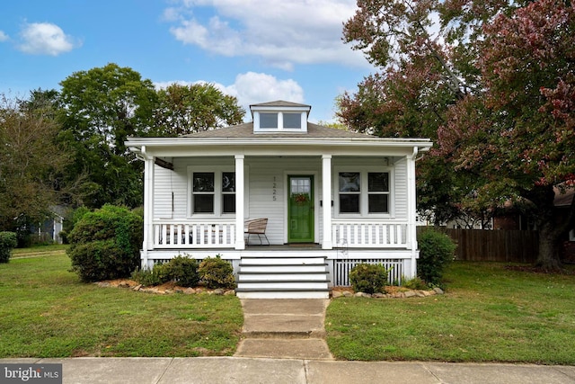 bungalow-style home featuring a front yard and a porch