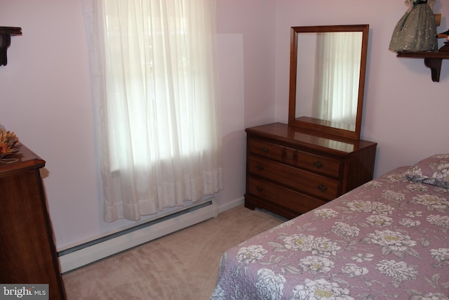 bedroom featuring baseboard heating and light colored carpet