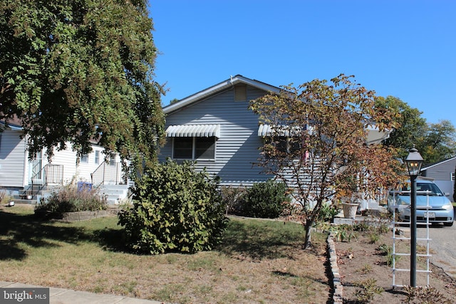 view of home's exterior with a yard