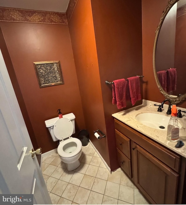 bathroom featuring vanity, toilet, and tile patterned flooring